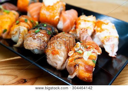 Fresh Sushi Rolls On Black Plate, Healthy And Delicious Traditional Asian Menu