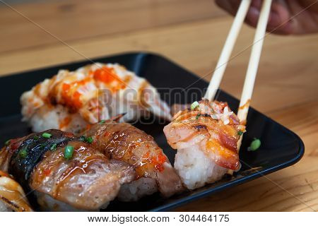 Close Up Fresh Homemade Sushi With Chopsticks On Plate.