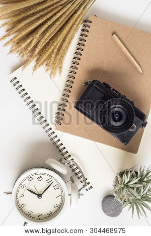 Travelling Planning Concept. Office Table Desk, Notbook, Camera, Flower. Flat Lay Composition, Socia