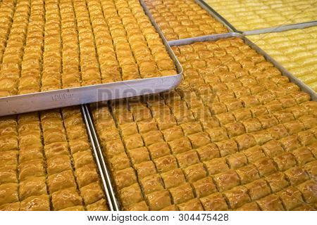 Traditional Turkish dessert Baklava close-up in the local Baklava shop in Turkey