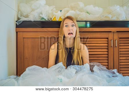 Woman Used Too Many Plastic Bags That They Filled Up The Entire Kitchen. Zero Waste Concept. The Con
