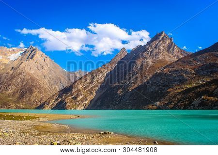 Deep Green Water Of Sheshnag Lake With Amarnath Mountains In The Background