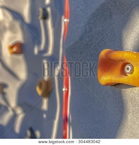 Square Bright Orange Foothold Or Handhold Of A Climbing Wall At A Playground