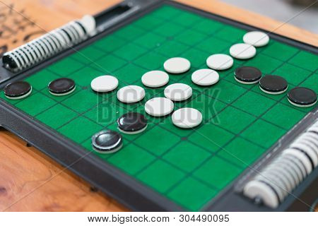 Closeup Discs On Green Reversi Board (othello),strategy Business Concept.