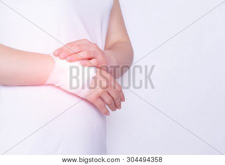 The Girl Is Holding Her Wrist On The Arm, Which Has A Healing Compress With Anesthesia, Treatment Of