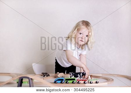 Little Cute Baby Boy (3 Years Old) Drinks Milk With Cookies And Plays In The Wooden Station Train Se