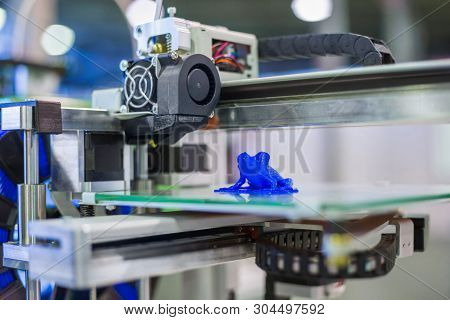 Automatic 3d Printer Machine Printing Plastic Model Of Blue Frog Toy At Modern Technology Exhibition