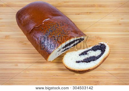 Piece And Slice Of The Pie With Sweet Crushed Poppy Seed Filling And Sprinkled With Whole Poppy Seed