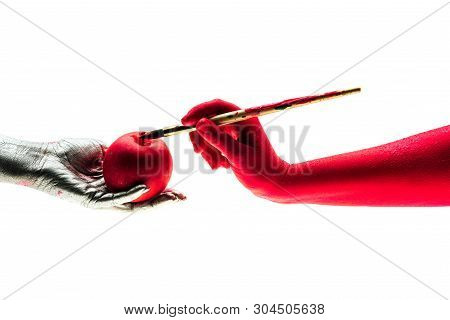 Hands Holding A Beautiful Red Apple And A Brush. Red Apple Preluding Sexsual Reletionship. Fake Frui