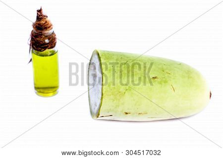 Raw Organic Cut Half Bottle Gourd Isolated On White Along With Its Extracted Beneficial Oil In A Sma