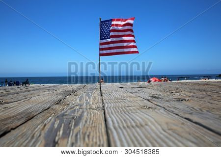 American Flag. American flags on the boardwalk on a beach. Laguna Beach California. Flags Waving for National Holidays.
