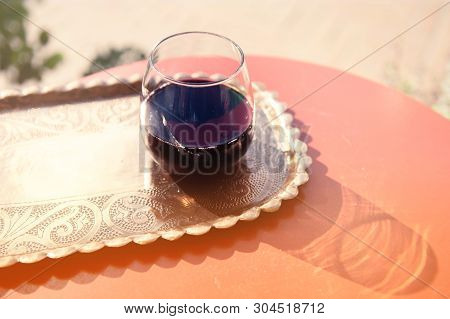 Glass Filled With Red Grape Juice. Musht Albanian Traditional Beverage