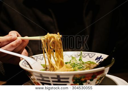 Man Grab Ramen Noodle Out Of Bowl By Chopsticks