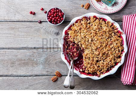 Cranberry Crumble, Crisp In A Baking Dish. Wooden Background. Top View. Copy Space