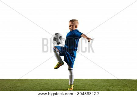 Young Boy As A Soccer Or Football Player In Sportwear Making A Feint Or A Kick With The Ball For A G