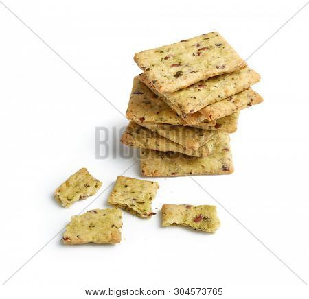 Tasty diet cerel crispbread with seeds and spices: heap of whole  crackers and one broken isolated on a white background with copy space.