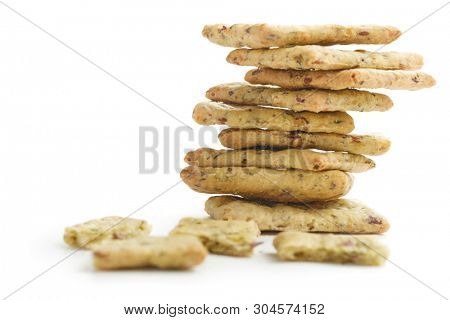 Tasty diet cerel crispbread with seeds and spices: heap of whole  crackers and one broken isolated on a white background
