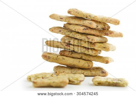 Tasty diet cerel crispbread with seeds and spices: heap of whole  crackers and one broken isolated on a white background