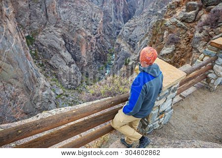 Tourist on the granite cliffs of the Black Canyon of the Gunnison, Colorado, USA
