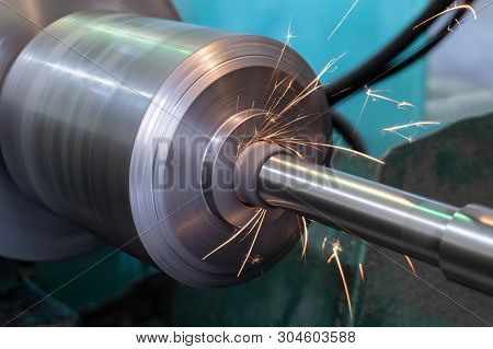 Internal Grinding Of A Metal Part On A Circular Grinding Machine With Sparks And Water Cooling.