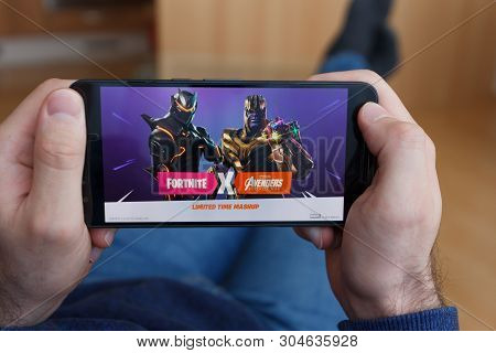 Los Angeles, California - June 3, 2019: Lying Man Holding A Smartphone And Playing The Fortnites Ave