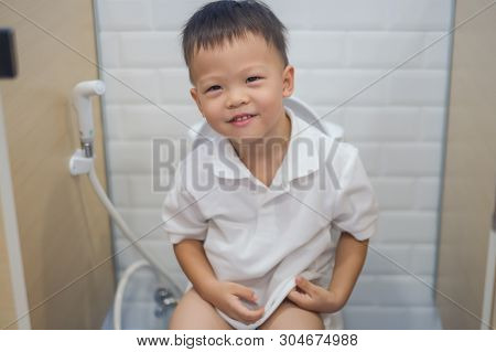 Cute Smiling Asian 2 - 3 Years Old Toddler Boy Child Sitting On Toilet Modern Style, Little Boy Use 