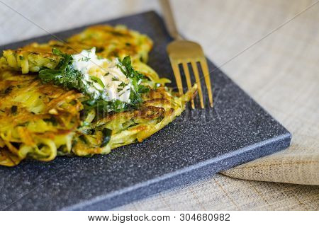 Roesti. Potatoes Grated With Greens, Fried In Butter. Serve On A Stone Board With Sour Cream, Garlic
