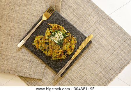 Roesti. Potatoes Grated With Greens, Fried In Butter. Serve On A Stone Board With Sour Cream, Garlic
