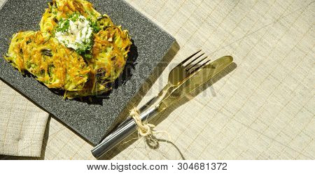 Roesti. Potatoes Grated With Greens, Fried In Butter. Serve On A Stone Board With Sour Cream, Garlic