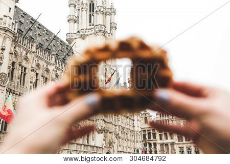 View Of Brussels Town Hall At The Grand Place In Brussels Through A Hole In The Traditional Belgian 