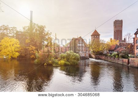 Ratsmuhle Or Old Water Mill And Wasserturm Or Water Tower On Ilmenau River At Morning In Luneburg. G