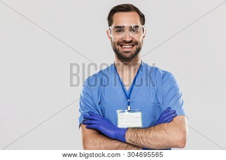 Portrait of cheerful young medical specialist working in hospital and wearing disposable sterile gloves isolated over white background