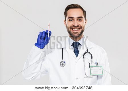 Portrait of caucasian young medical doctor wearing disposable sterile gloves working in hospital and holding syringe isolated over white background