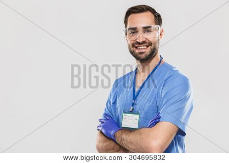 Portrait of handsome young medical specialist working in hospital and wearing disposable sterile gloves isolated over white background