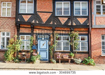 Luneburg, Germany - November 04, 2018: Medieval Old Brick Building Decorated By Plants In Luneburg