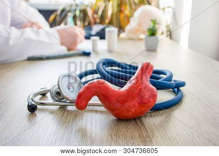 Concept Photo Of Diagnosis And Treatment Of Stomach. In Foreground Is Model Of Stomach Near Stethosc