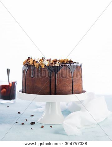 Easy Birthday Drip Cake With Melted Chocolate Ganache With Party Decor On A White Background. Copy S