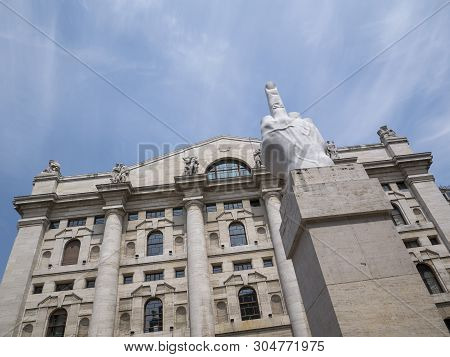 Milan, Italy - May 25, 2019: Mezzanotte Palace Facade And Middle Finger Sculpture In Milan Stock Exc