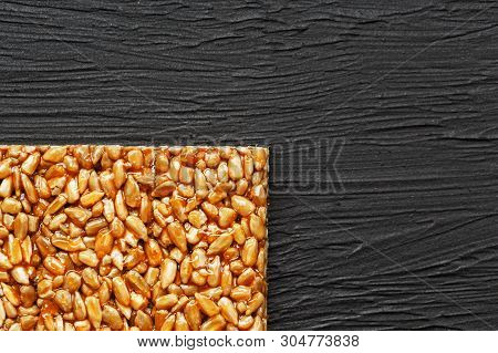 Tile Kozinaki From Sunflower Seeds On A Black Textural Background. Delicious Oriental Sweets Gozinak