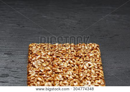 Tile Kozinaki From Sunflower Seeds On A Black Textural Background. Delicious Oriental Sweets Gozinak