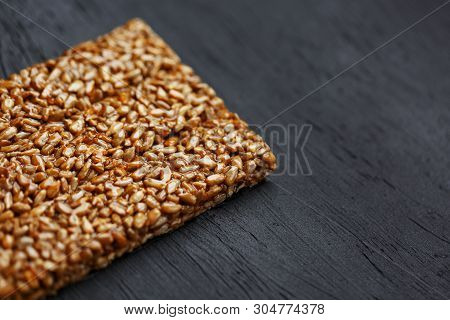 Tile Kozinaki From Sunflower Seeds On A Black Textural Background. Delicious Oriental Sweets Gozinak