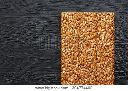 Tile Kozinaki From Sunflower Seeds On A Black Textural Background. Delicious Oriental Sweets Gozinak