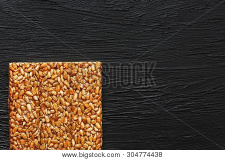 Tile Kozinaki From Sunflower Seeds On A Black Textural Background. Delicious Oriental Sweets Gozinak