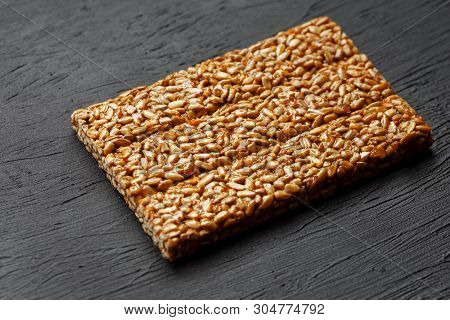 Tile Kozinaki From Sunflower Seeds On A Black Textural Background. Delicious Oriental Sweets Gozinak