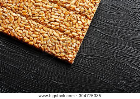 Tile Kozinaki From Sunflower Seeds On A Black Textural Background. Delicious Oriental Sweets Gozinak
