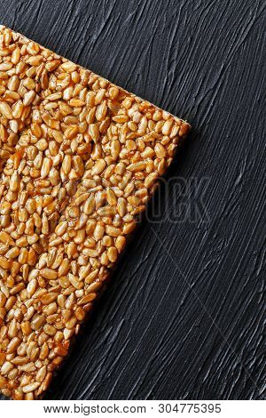 Tile Kozinaki From Sunflower Seeds On A Black Textural Background. Delicious Oriental Sweets Gozinak
