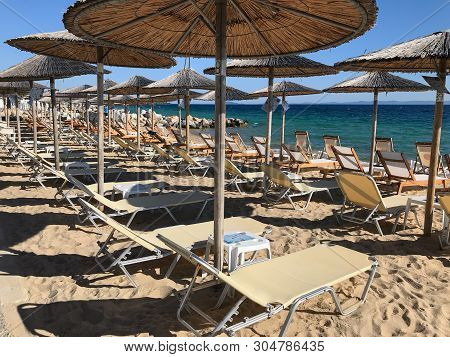 Nikiti Beach Is In The Village Of Nikiti With Sun Beds And Umbrellas, Sithonia Peninsula, Chalkidiki