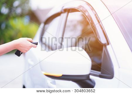 Closeup Woman Hand Holding The Remote Control Car Alarm Systems
