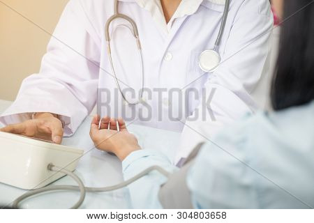 Nurse Taking Hospice Patient Blood Pressure In Hospital