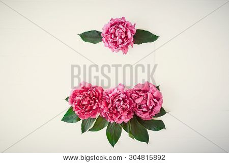 Flower Border Pattern Frame Made Of Bright Pink Buds Peony Bouquet On A White Wooden Background. Flo